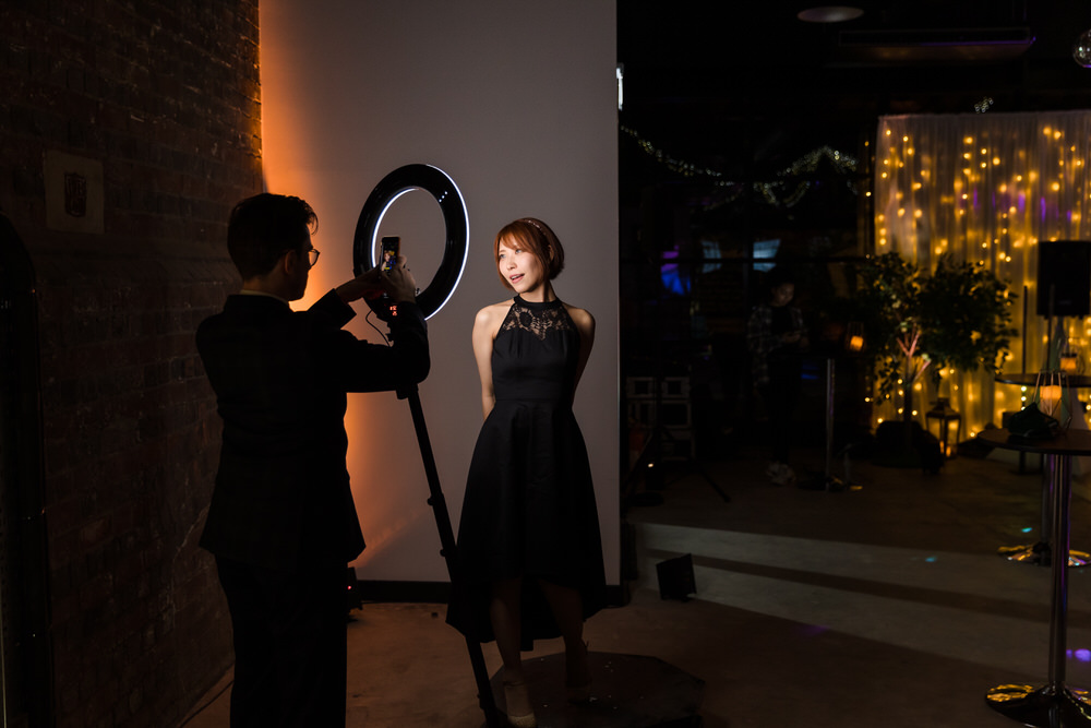 Professional 360 photo booth attendant with ring light at a Birmingham wedding event