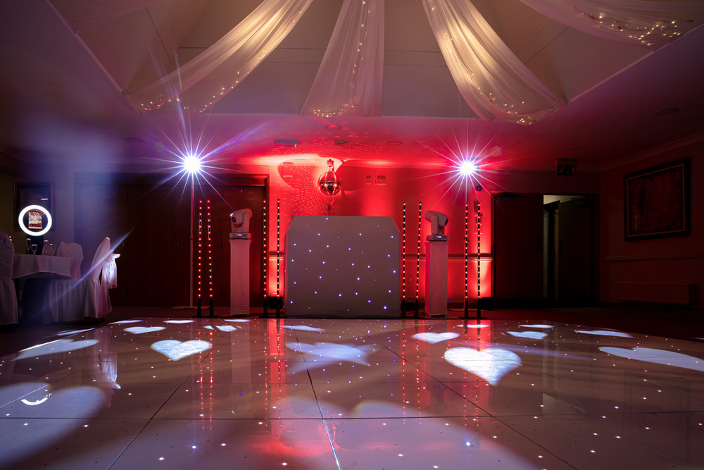 Blue Diamond Entertainment wedding DJ setup with starlit booth, LED uplighting, and heart gobos projected onto the dance floor at Wharton Park, Bewdley, Worcestershire